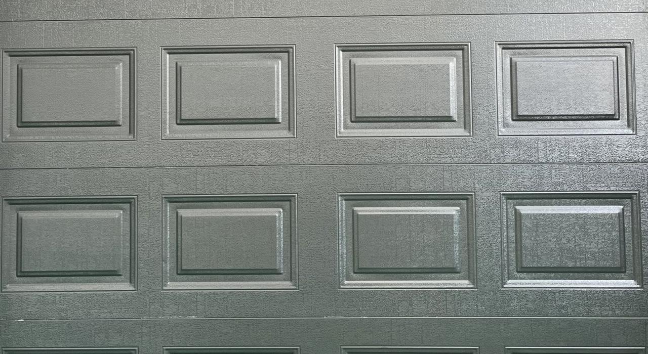Raised panel garage door undergoing factory inspection