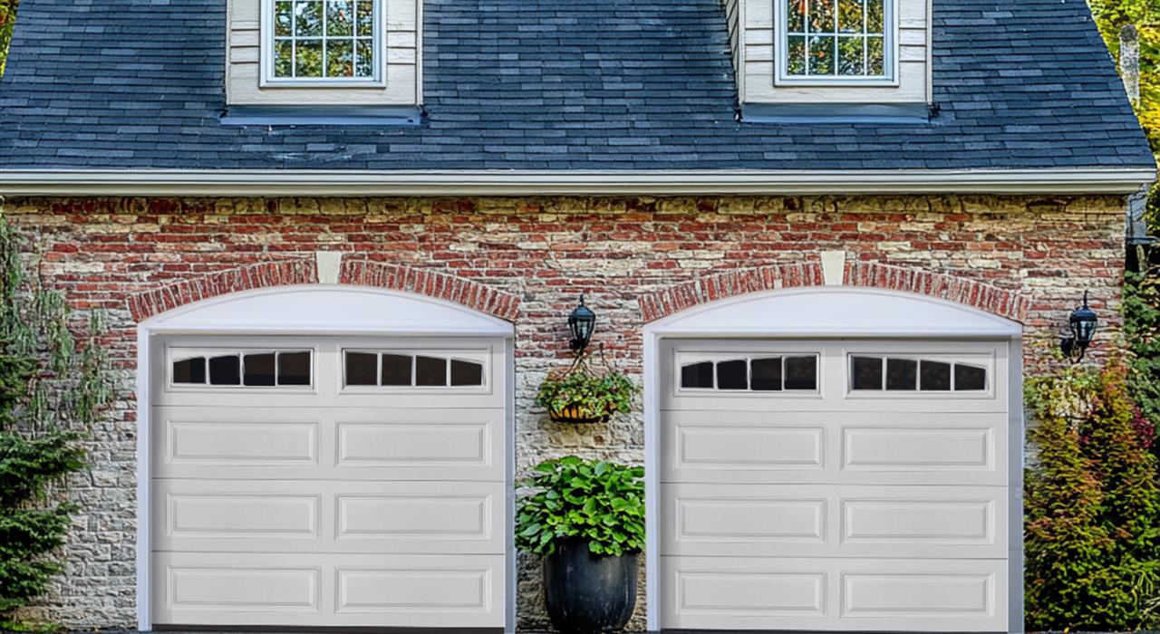 White garage doors on a classic brick home